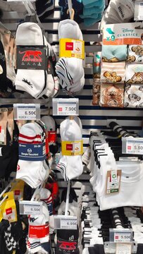 Royan, France - July 25, 2026: E.Leclerc ROYAN CEDEX. Display of various sock brands including Disney Classics, featuring colorful designs and price tags in a retail store setting