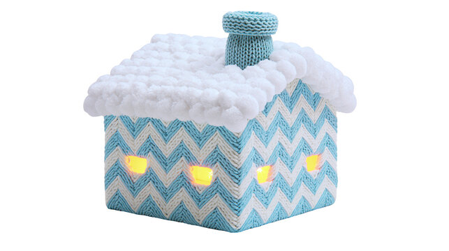 Knitted blue and white chevron house with fluffy snow roof and lit windows, isolated on transparent background