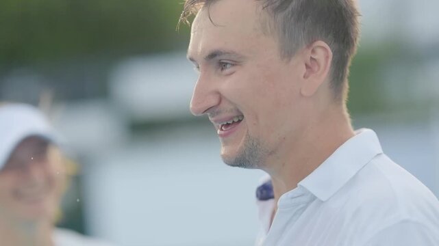 Man spitting water out of his mouth and laughing