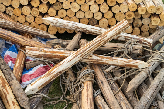 Pile of sharp wood,stack of wooden fence posts arranged erractically