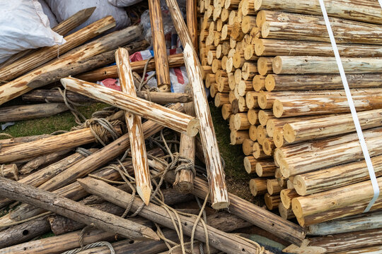 Pile of sharp wood,stack of wooden fence posts arranged erractically