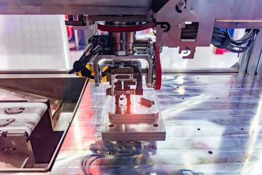 Automated process industrial robot loading metal part. Industrial manufacturing