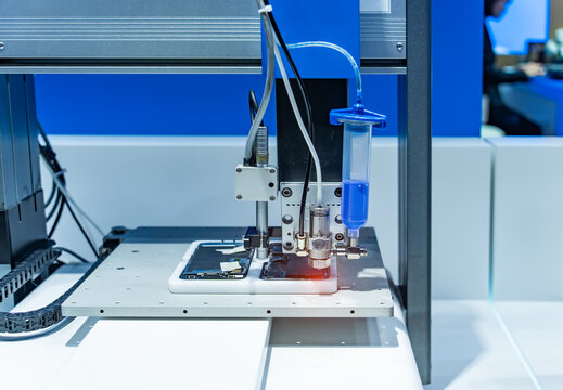 Robot holding glue syringe Injection in mobile phone factory