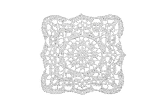 Square white crochet lace doily with circular floral center