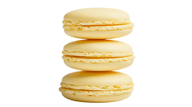 Stack of three pale yellow macarons with creamy filling, isolated on transparent background