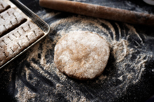 Raw rectangular Finnish rye flatbread dough on a floured surface.
