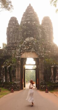Slow Motion Woman Spinning at Bayon Temple Gate Cambodia