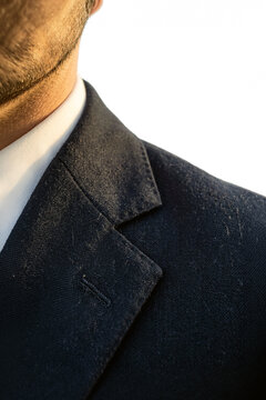 Close-up of a man wearing a dark wool suit jacket