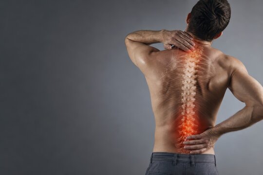Man Experiencing Back Pain with Emphasis on Spine Pain Point in Studio Lighting
