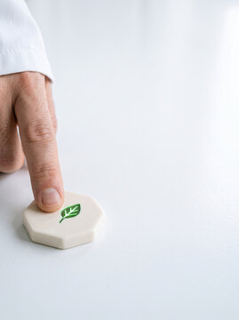 Finger Pressing Hexagonal Eco Button with Green Leaf Icon