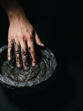 Hand Kneading Natural Dark Mineral Mud Mask in Stone Bowl