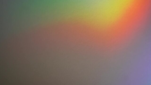 Soft rainbow refraction and blurred defocused light streaks appear on a dark abstract background. Concept digital design, banners, websites, advertising and editorial layouts.