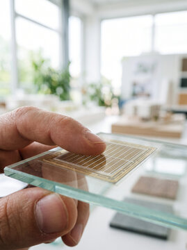 Finger Touching Transparent Micro-Grid Glass Panel in Bright Modern Office