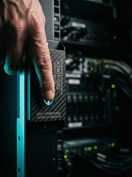 Finger Pressing Quantum Key Distribution QKD Token Button on Server Rack