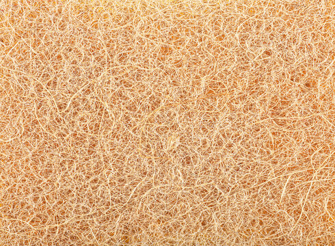 Yellow  pattern on the surface of the natural material sponge. Abstract brown fluffy background.