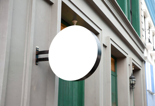 Blank white round outdoor signboard mockup on modern building wall