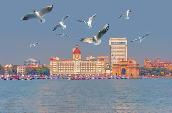 The Gateway of India and boats in the background Taj Mahal Hotel - Mumbai, India