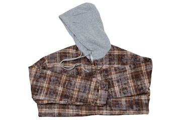 Folded brown hooded plaid flannel shirt isolated on white background. Warm fleece lined check shacket with grey hood in flat lay arrangement © aneduard