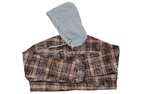 Folded brown hooded plaid flannel shirt isolated on white background. Warm fleece lined check shacket with grey hood in flat lay arrangement