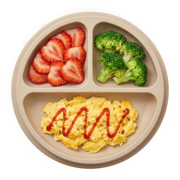 Healthy toddler meal with scrambled eggs broccoli and sliced strawberries in a divided plate isolated on transparent background