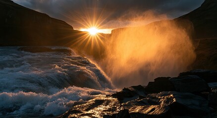 Fototapeta premium Golden sunburst illuminates powerful waterfall in rugged landscape