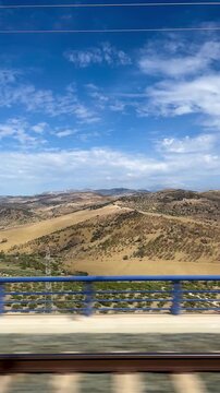 Window view of Andalusian landscapes from a moving train