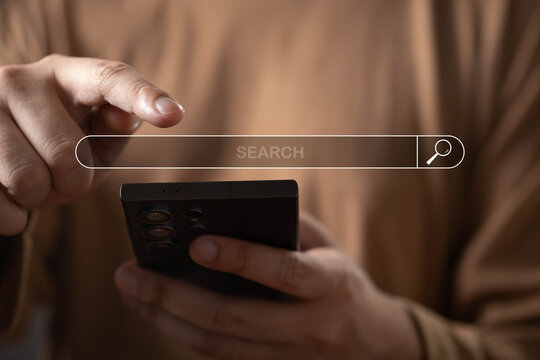 Online search and mobile browsing concept with a user using a smartphone and digital search interface. Information discovery, web navigation, search engine optimization, research and technology.