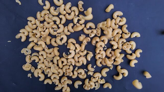 Elbow pasta in kitchen , Slow Motion Italian Kitchen Ingredient Close-Up ,