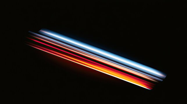 Abstract streaks of light trail across a dark background, creating a dynamic effect