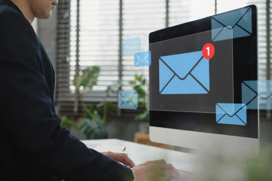 Professional worker checking multiple incoming email messages on computer screen in office.