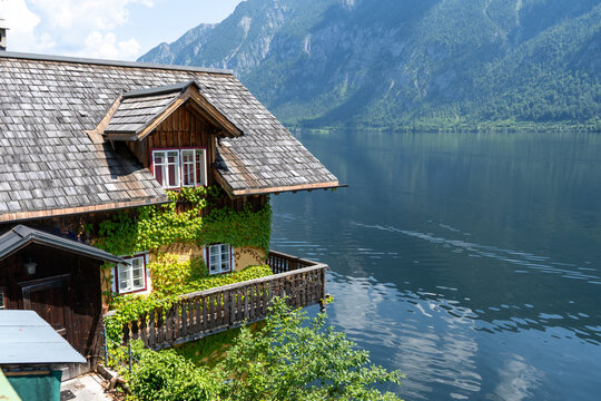 Hallstatt old traditional Wooden House with Wooden Balcony in Alpine Village rural landscape. Hallstatt, Austria lake water nature