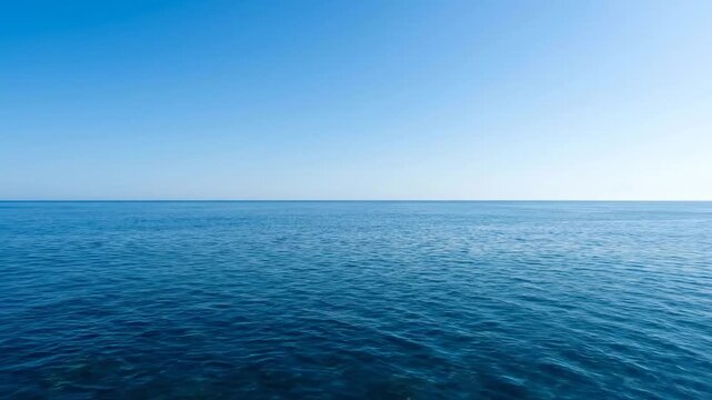 View of blue ocean and clear sky at midday with no clouds