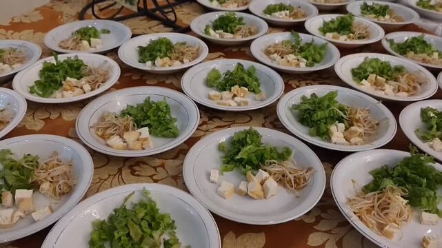 Traditional Indonesian Tahu Campur served in bowls with tofu, beef, vegetables, fried crackers, and savory broth. A close-up of an authentic East Javanese street food dish, freshly prepared and ready 
