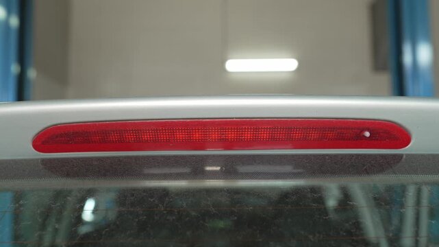 A third brake light is integrated into a car spoiler.