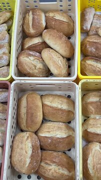 Assortment of freshly baked bread displayed in a bakery. Vertical UGC 