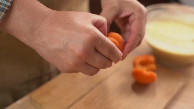 Female Hands Splitting Apricots for Homemade Baking Desserts