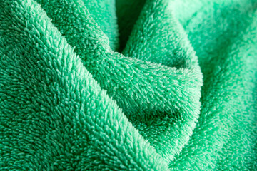 Green Microfiber Fabric Texture Abstract Background with Soft Folds © chaophrayaart