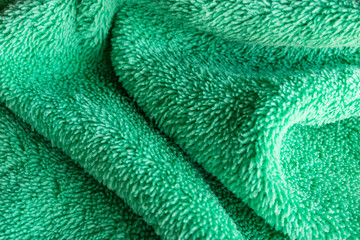 Green Microfiber Fabric Texture Abstract Background with Soft Folds © chaophrayaart