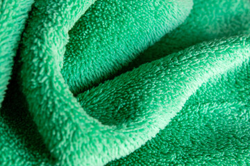 Green Microfiber Fabric Texture Abstract Background with Soft Folds © chaophrayaart