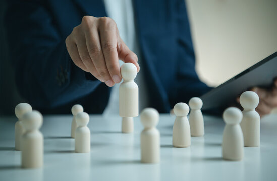 Human resources recruitment concept with wooden figures and manager selecting candidate supporting talent acquisition workforce planning employee evaluation and organizational growth