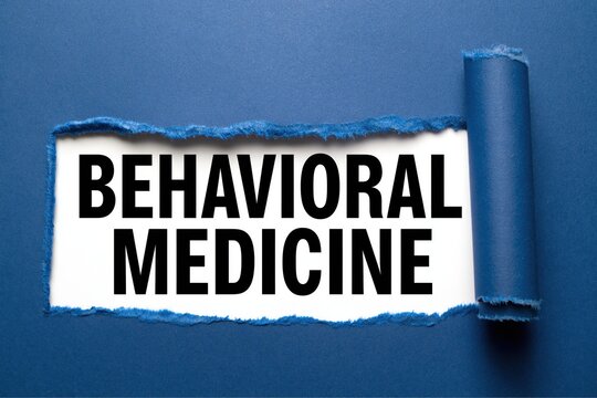 Black text behavioral medicine written under torn blue paper