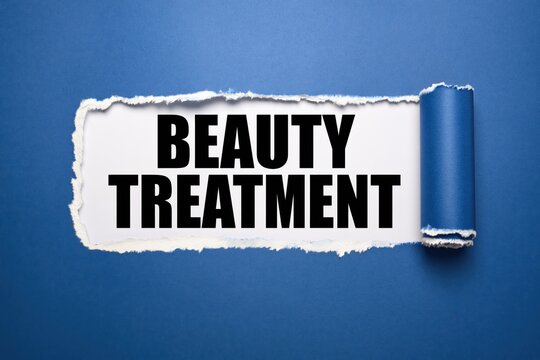Black text beauty treatment written under torn blue paper