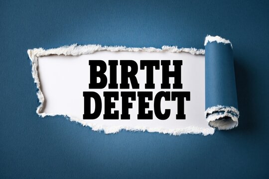 Black text birth defect written under torn blue paper