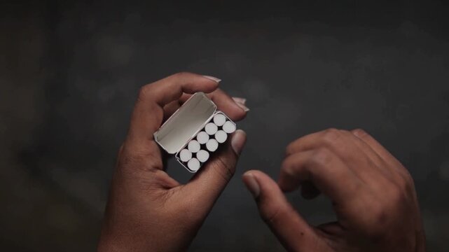Concept of showing leaving cigarette addiction in dark room.