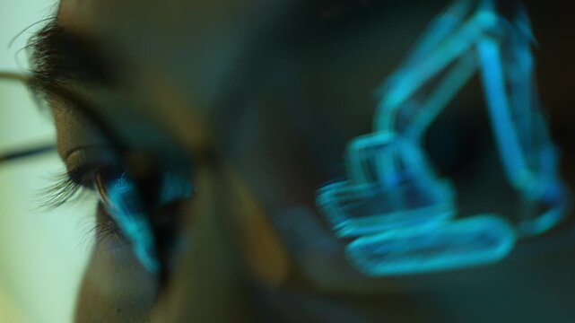 An industrial engineer wearing eyeglasses examines a digital heavy machinery model on a futuristic display, symbolizing smart manufacturing, industrial automation, engineering precision. 4k.
