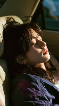 A woman sleeping in a car creates a calm lifestyle visual emphasizing comfort, safety, and modern transportation.