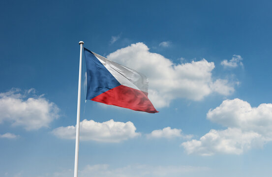 Czech Republic flag waving in beautiful sky.