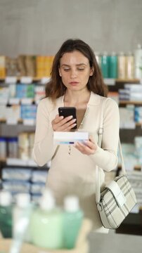 Adult woman buyer scanning qr code for box of ointment in pharmacy