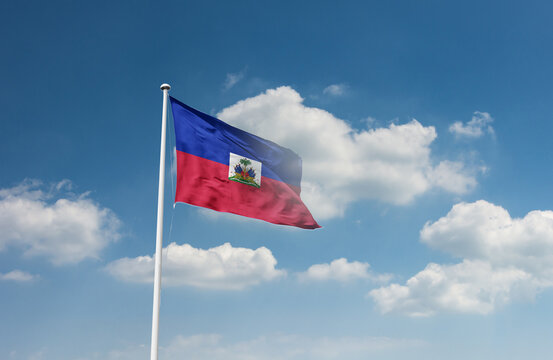 Haiti flag waving in beautiful sky.