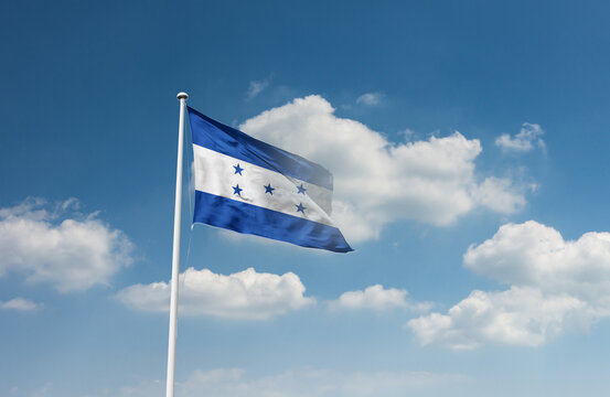 Honduras flag waving in beautiful sky.